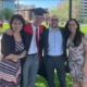 Photo shows a college graduate in cap and gown with his proud parents