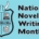 Logo for NaNoWriMo, showing an aqua blue with a shield showing writing utensils, topped with Viking horns, beside the words "National Novel Writing Month"